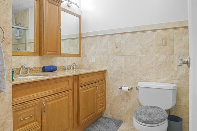 Harmon Cove Tower 426, Secaucus, NJ 07094 - bathroom with double vanity, tile walls, and toilet