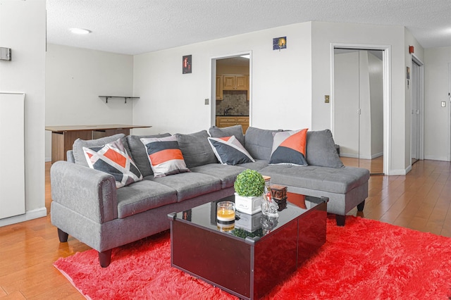 Harmon Cove Tower 426, Secaucus, NJ 07094 - living room featuring hardwood / wood-style flooring and a textured ceiling