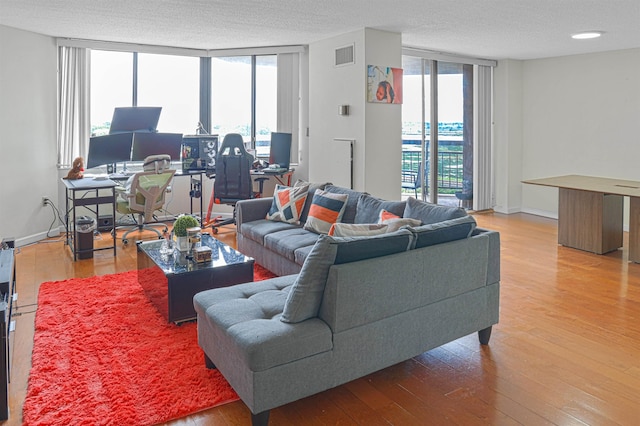 Harmon Cove Tower 426, Secaucus, NJ 07094 - living area with a desk, hardwood / wood-style flooring, expansive windows, a textured ceiling, and baseboards