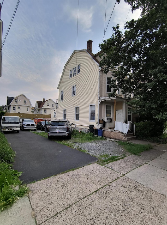 137 76th St, North Bergen, NJ 07047 - view of property exterior with a chimney and a gambrel roof