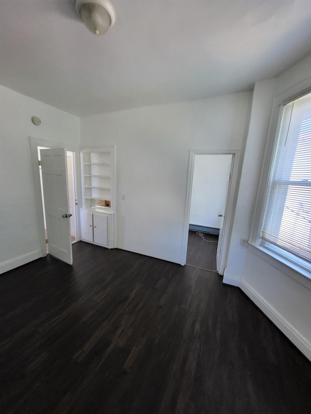 137 76th St, North Bergen, NJ 07047 - unfurnished room with dark wood-type flooring and baseboards