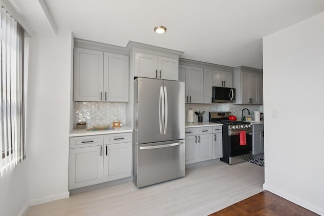 10 Huron Ave Unit 11D, Jersey City, NJ 07306 - kitchen featuring appliances with stainless steel finishes, gray cabinets, light countertops, and backsplash