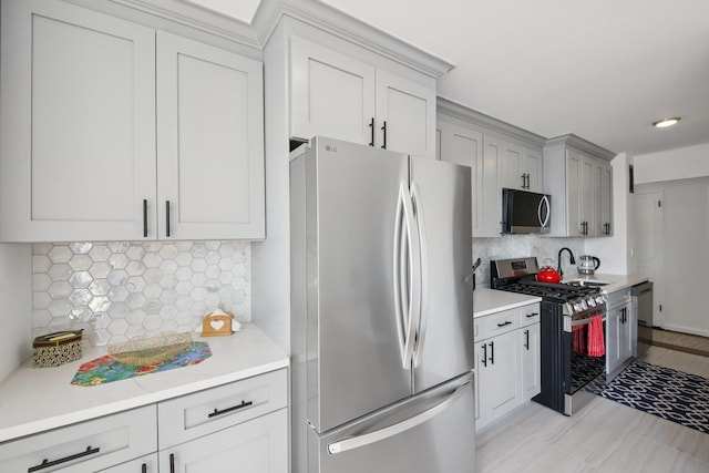 10 Huron Ave Unit 11D, Jersey City, NJ 07306 - kitchen featuring stainless steel appliances, decorative backsplash, light countertops, and gray cabinetry
