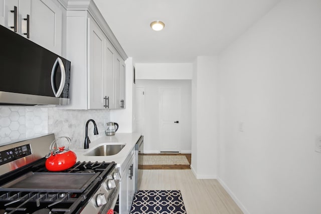 10 Huron Ave Unit 11D, Jersey City, NJ 07306 - kitchen with appliances with stainless steel finishes, tasteful backsplash, light countertops, and white cabinetry