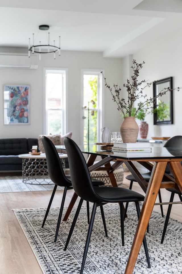 dining area featuring a notable chandelier and hardwood / wood-style flooring