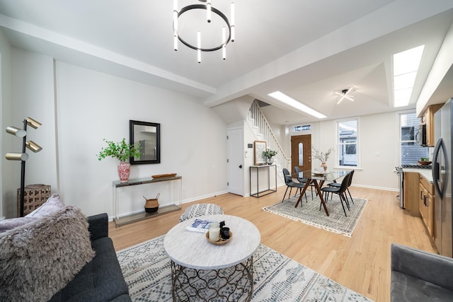 living room with lofted ceiling and light hardwood / wood-style flooring