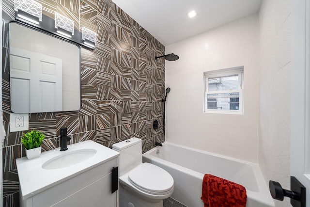 full bathroom with tiled shower / bath combo, vanity, tile walls, and toilet