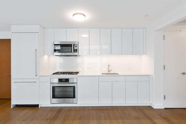 99 Hudson St Unit 601, Jersey City, NJ 07302 - kitchen with stainless steel appliances, a sink, modern cabinets, and white cabinets