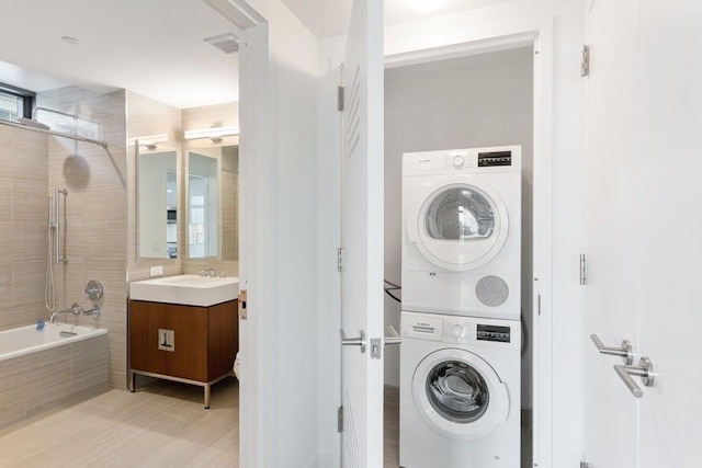 99 Hudson St Unit 601, Jersey City, NJ 07302 - laundry room with stacked washer and clothes dryer and light wood-style floors