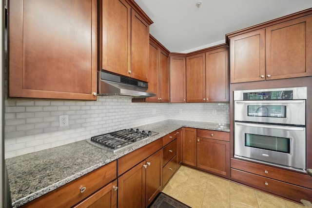 28 Creekside Ct Unit 28, Secaucus, NJ 07094 - kitchen with stainless steel appliances, under cabinet range hood, light stone countertops, and backsplash