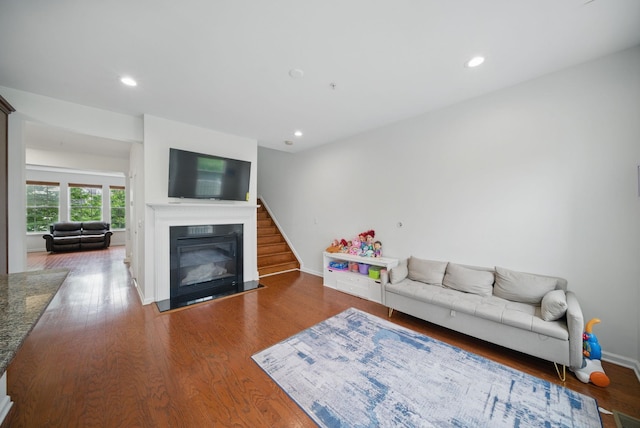 28 Creekside Ct Unit 28, Secaucus, NJ 07094 - living area featuring a glass covered fireplace, recessed lighting, wood finished floors, stairway, and baseboards