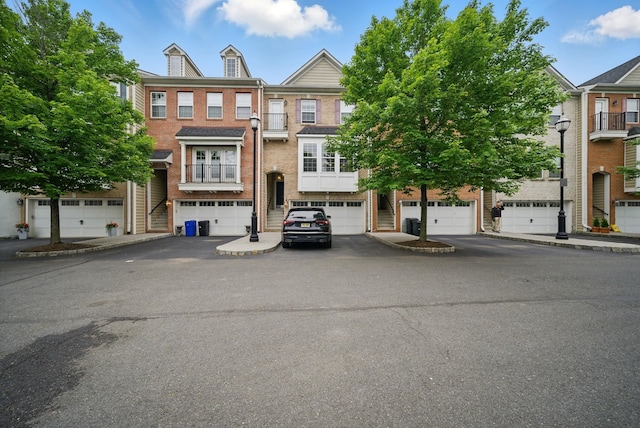 28 Creekside Ct Unit 28, Secaucus, NJ 07094 - view of front of house with driveway, an attached garage, and brick siding