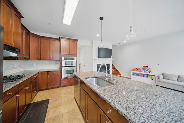 28 Creekside Ct Unit 28, Secaucus, NJ 07094 - kitchen featuring a sink, appliances with stainless steel finishes, under cabinet range hood, open floor plan, and backsplash