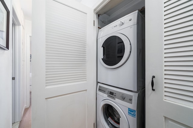 clothes washing area with laundry area and stacked washer / dryer