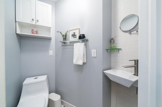 half bathroom with toilet and a sink