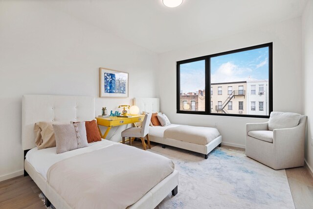 413 Monroe St Unit 200, Hoboken, NJ 07030 - bedroom with light wood-style floors, baseboards, and vaulted ceiling