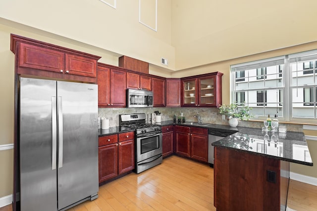 769 Montgomery St Unit 211, Jersey City, NJ 07306 - kitchen featuring stainless steel appliances, dark brown cabinets, and light wood-type flooring