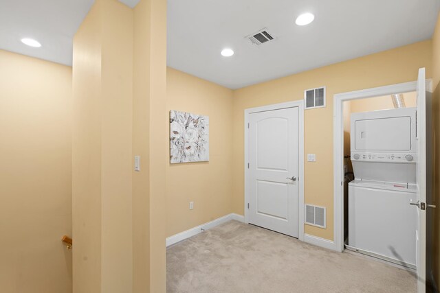 769 Montgomery St Unit 211, Jersey City, NJ 07306 - laundry room featuring estacked washer and dryer, light carpet, and recessed lighting