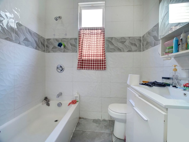 bathroom with vanity, a bath, tile walls, and toilet