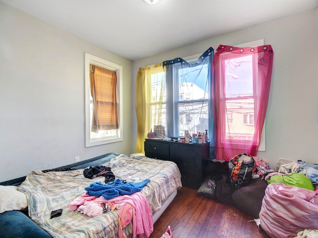 bedroom with dark hardwood / wood-style flooring