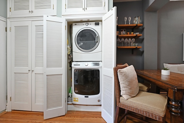 127 Park Ave Unit 2, Hoboken, NJ 07030 - laundry room with stacked washer / dryer, light wood-style floors, and a desk