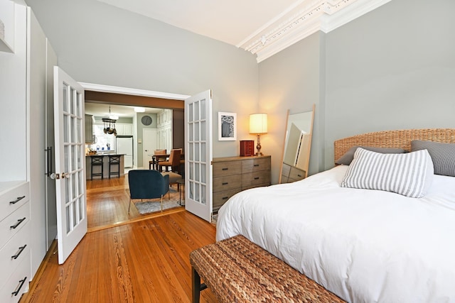 127 Park Ave Unit 2, Hoboken, NJ 07030 - bedroom featuring french doors, light wood-style flooring, freestanding refrigerator, a towering ceiling, and crown molding