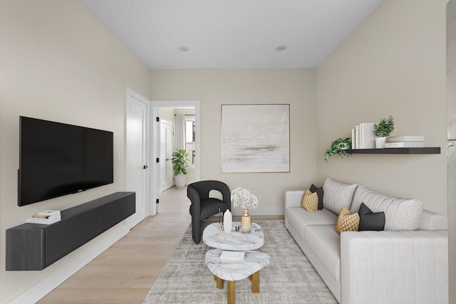 living area with light wood finished floors and baseboards