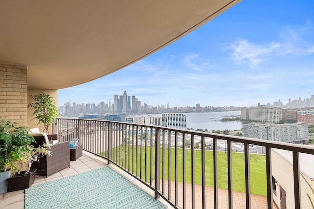 balcony featuring a water view and a view of city