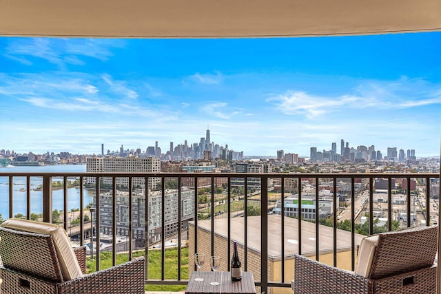balcony featuring a city view and a water view