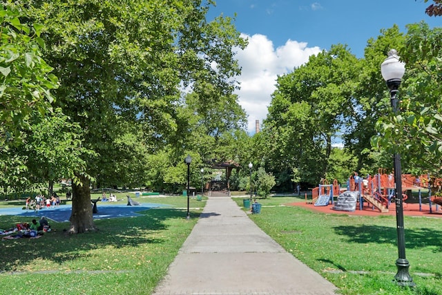 surrounding community featuring playground community and a lawn