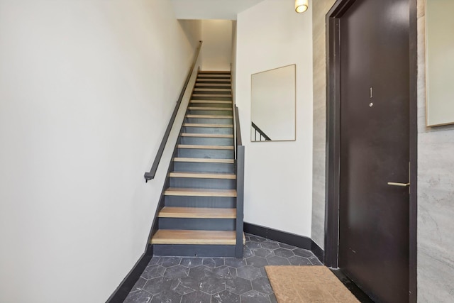 stairway featuring baseboards