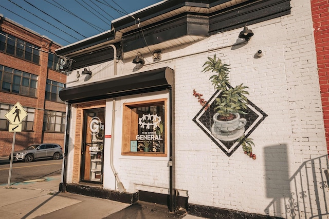 entrance to property featuring brick siding