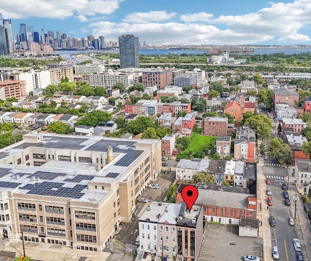 birds eye view of property with a water view and a view of city