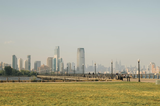 surrounding community with a city view and a yard