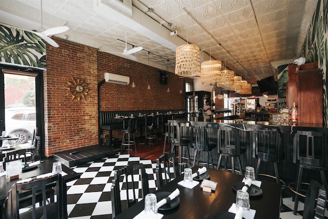 interior space featuring bar, brick wall, and a wall mounted air conditioner