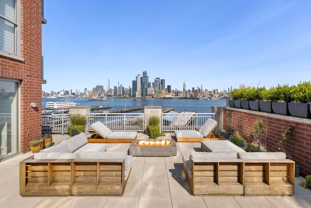 1125 Maxwell Ln Unit 654, Hoboken, NJ 07030 - view of patio featuring a view of skyline, an outdoor living space with a fire pit, and a water view