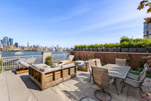 1125 Maxwell Ln Unit 654, Hoboken, NJ 07030 - view of patio / terrace with a view of skyline, outdoor dining space, and an outdoor living space with a fire pit