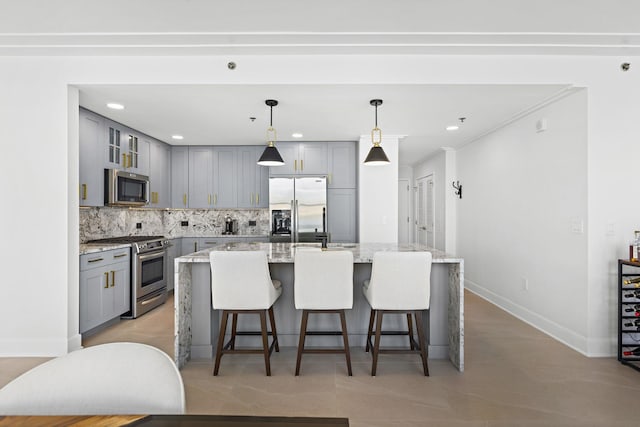 1125 Maxwell Ln Unit 654, Hoboken, NJ 07030 - kitchen with stainless steel appliances, gray cabinetry, decorative backsplash, a breakfast bar area, and baseboards