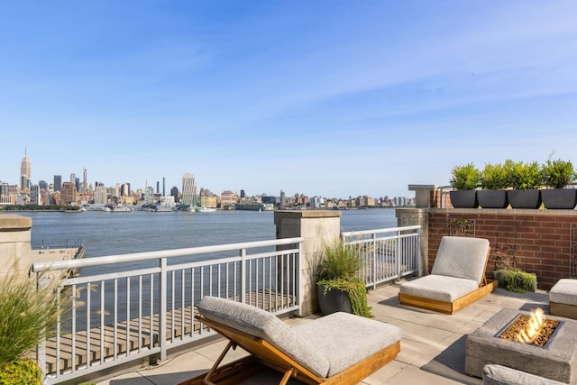 1125 Maxwell Ln Unit 654, Hoboken, NJ 07030 - wooden deck featuring a fire pit, a skyline view, and a water view