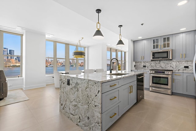1125 Maxwell Ln Unit 654, Hoboken, NJ 07030 - kitchen featuring appliances with stainless steel finishes, gray cabinets, a sink, tasteful backsplash, and recessed lighting