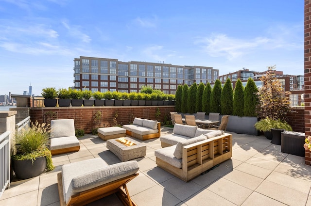 1125 Maxwell Ln Unit 654, Hoboken, NJ 07030 - view of patio featuring an outdoor living space with a fire pit and outdoor dining area