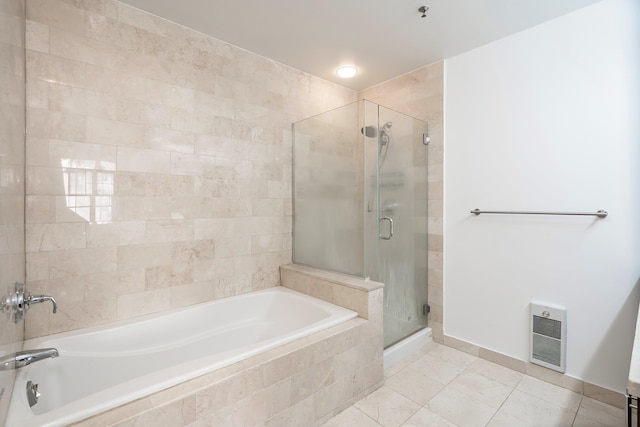 full bathroom with a shower stall and tiled tub