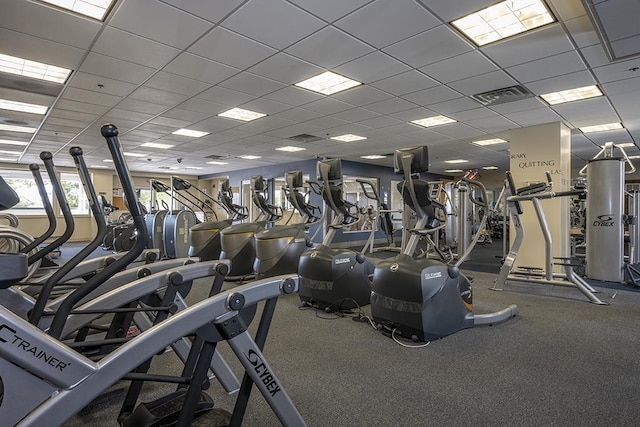 workout area featuring a paneled ceiling and visible vents