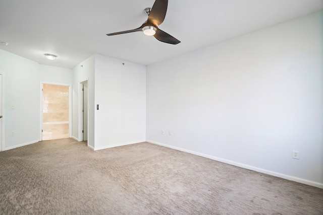 spare room with baseboards, carpet floors, and ceiling fan