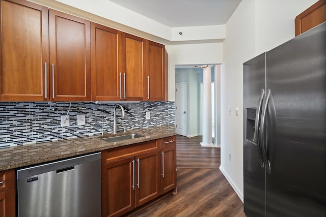 kitchen with tasteful backsplash, fridge with ice dispenser, dark wood-style flooring, stainless steel dishwasher, and a sink