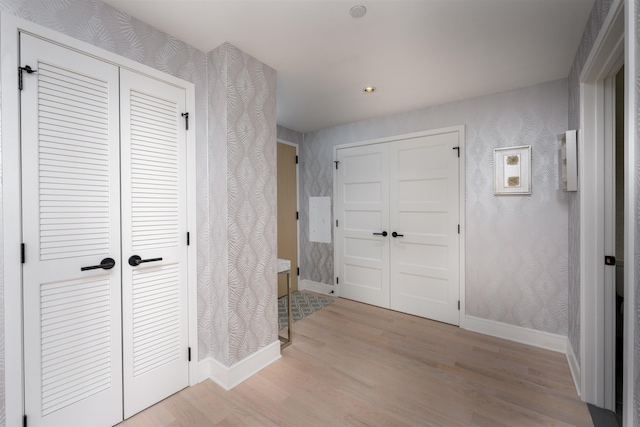 corridor with light wood-type flooring