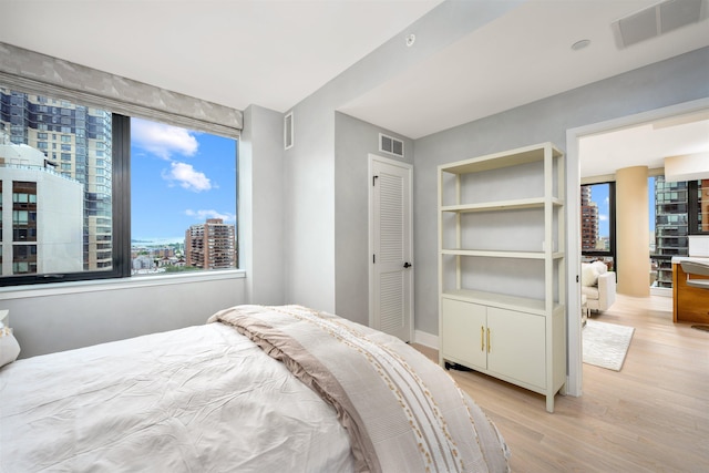 bedroom with a closet and light hardwood / wood-style flooring