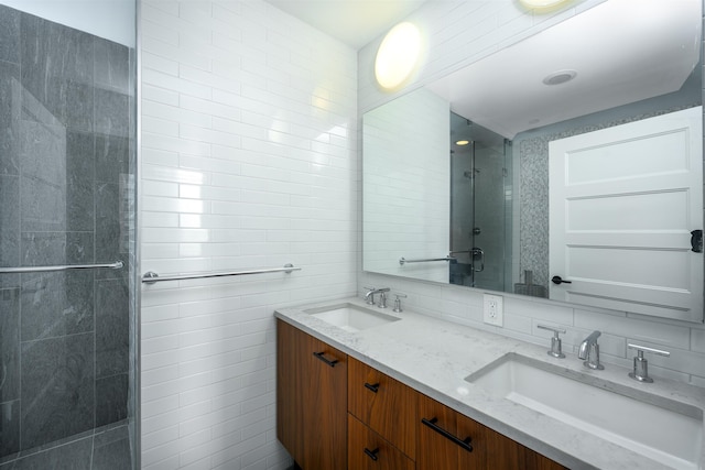 bathroom featuring vanity, decorative backsplash, tile walls, and an enclosed shower