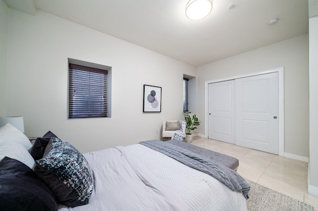 96 Tidewater St Unit 1G, Jersey City, NJ 07302 - bedroom featuring light tile patterned flooring, a closet, and baseboards