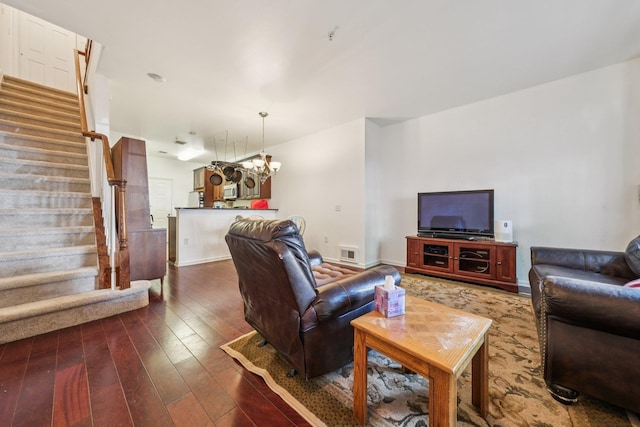 265 Custer Ave Unit 103, Jersey City, NJ 07305 - living area with stairway, dark wood-type flooring, and a chandelier
